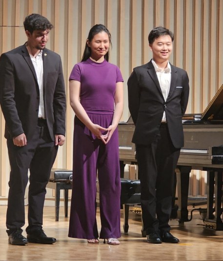 Pianists on stage at the Piano Arts competition, Quang Vo at right