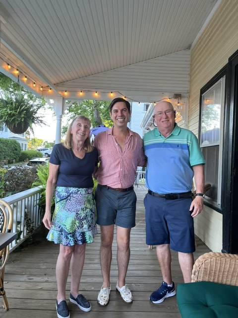 Three people on the porch of the Pentagoet Inn in Castine, Maine