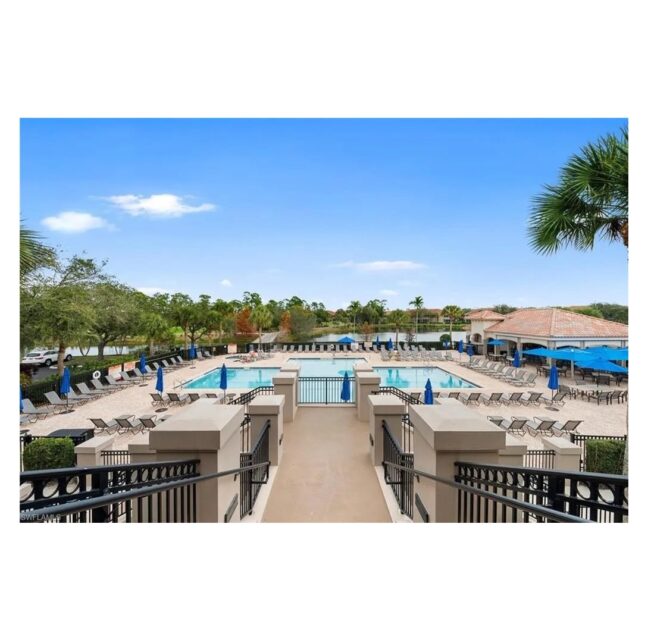 Grandezza community pool and clubhouse terrace under a clear Southwest Florida sky