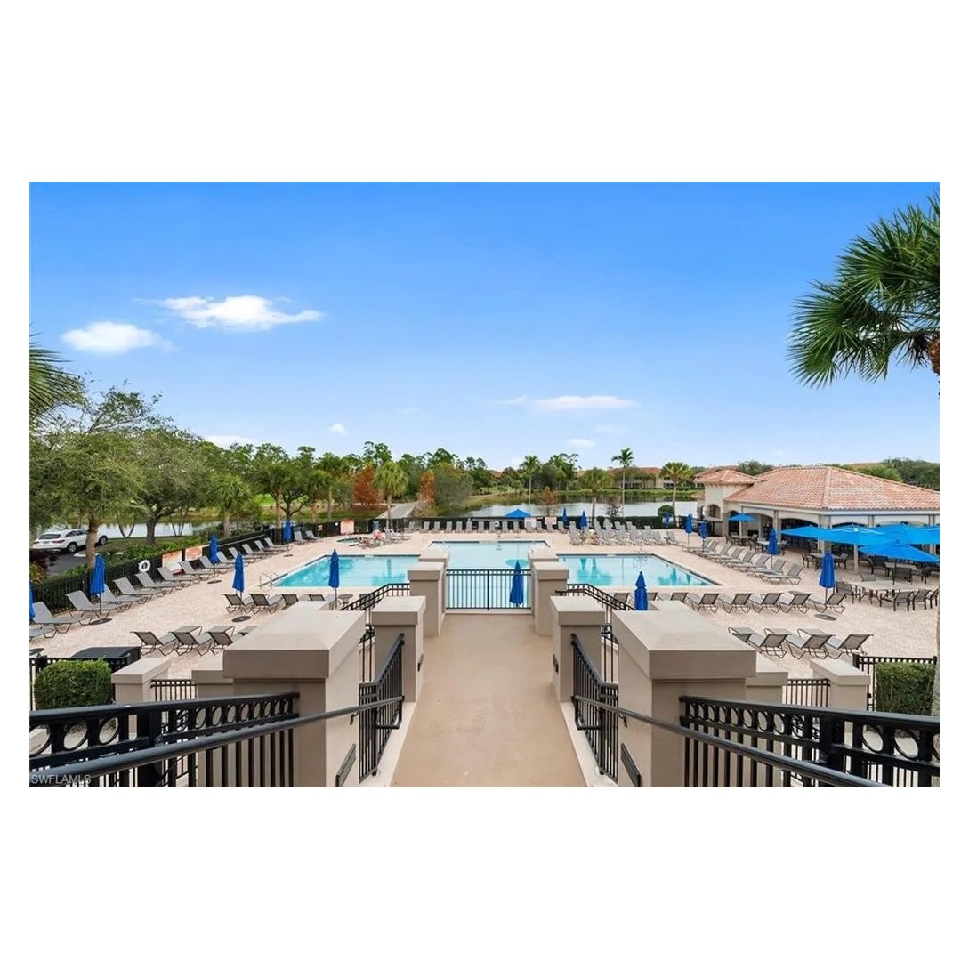 Grandezza community pool and clubhouse terrace under a clear Southwest Florida sky