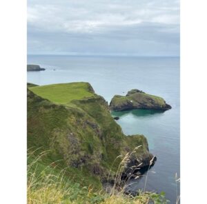 Green cliffs and sea stacks on the Antrim Coast at Carrick-a-Rede, Ireland