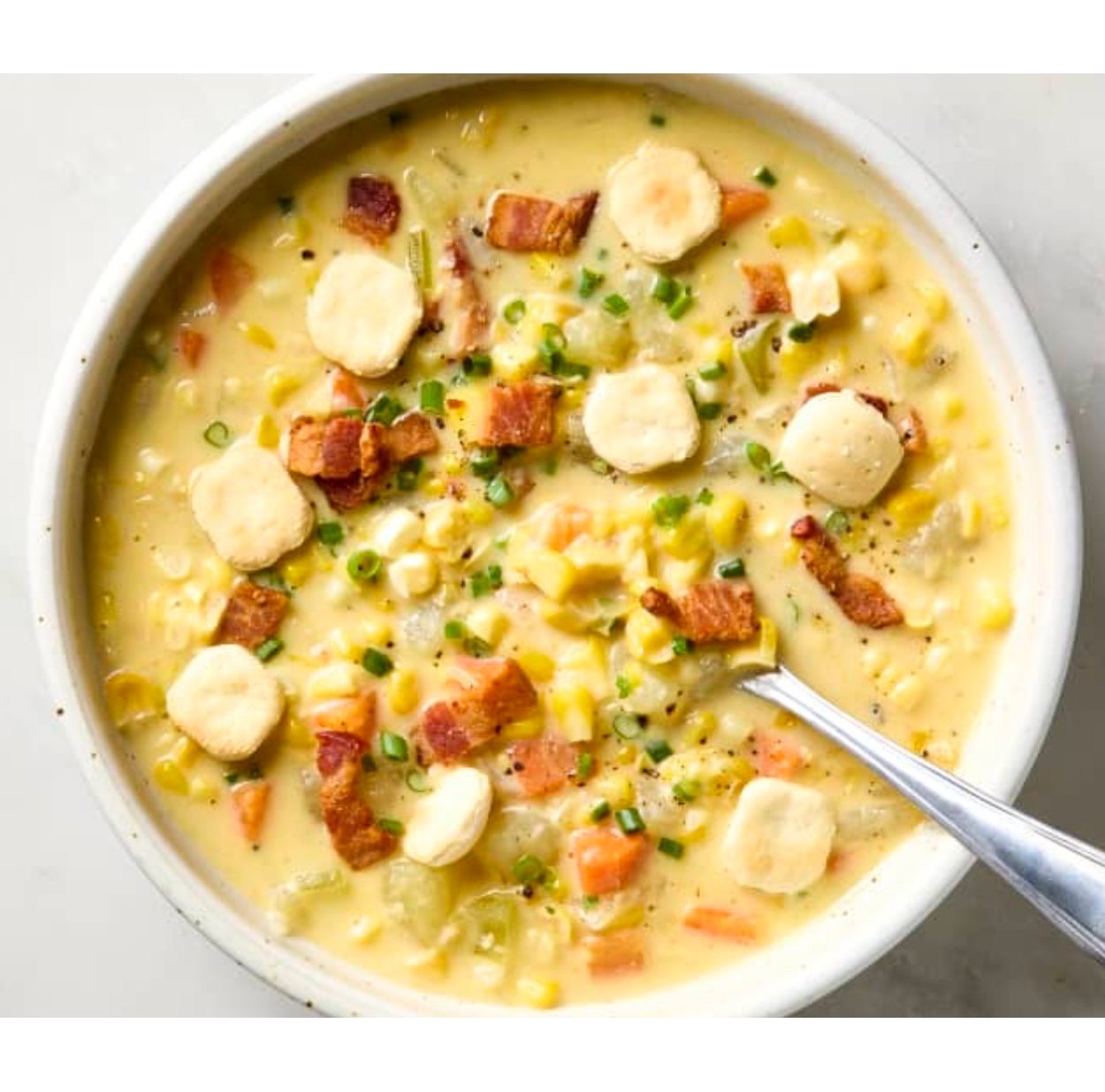 Bowl of corn chowder with bacon, potatoes, corn and chives